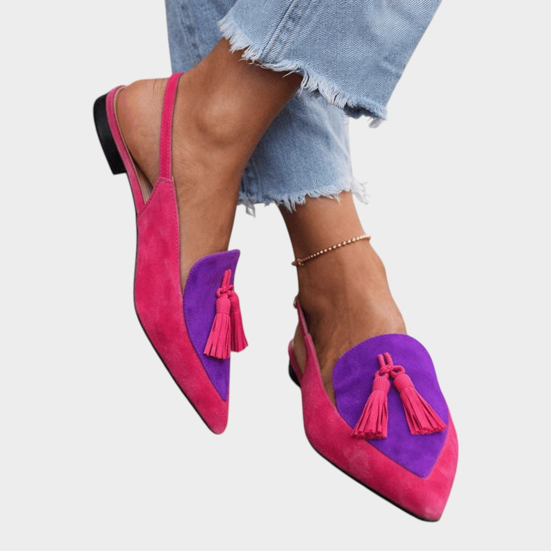 Women wearing pink and purple strappy tassel flat sandals