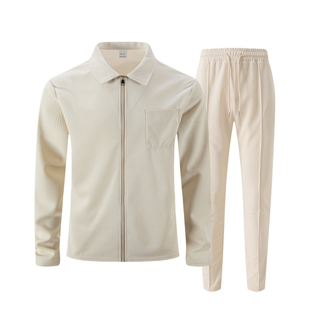 Flat lay of beige zip jacket and trousers set