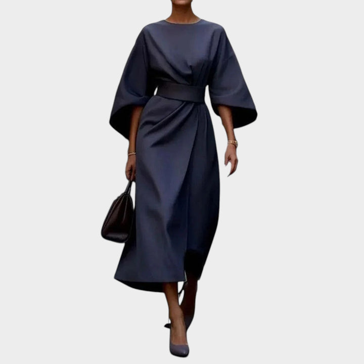 Woman wearing dark blue kimono sleeve maxi dress with defined waist