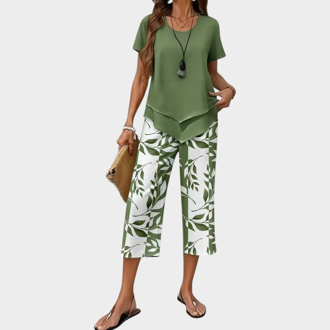 Woman wearing a green casual printed two-piece set with asymmetrical top and cropped wide-leg pants