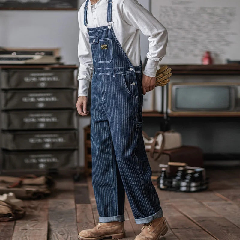 Man wearing striped blue indigo overalls in a rustic setting