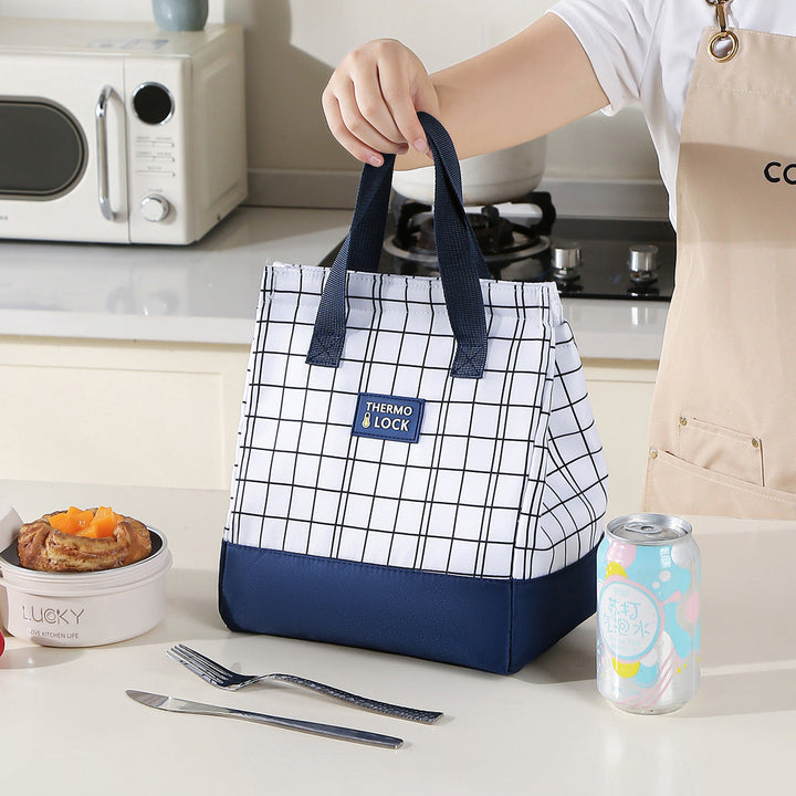 Woman carrying grid pattern thermal cooler tote for daily commuting