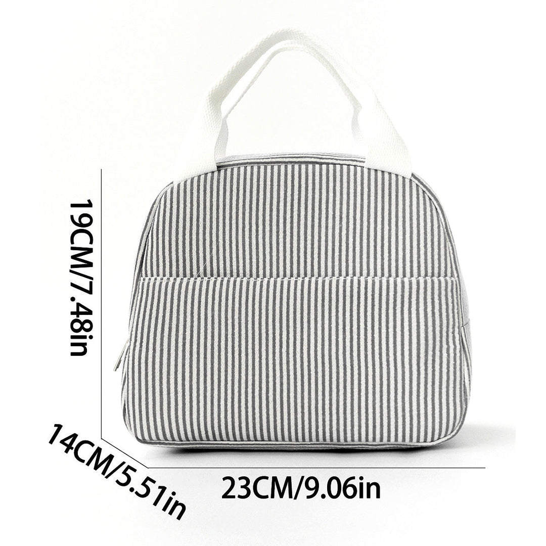 Lifestyle shot of striped insulated lunch bag carried by handle