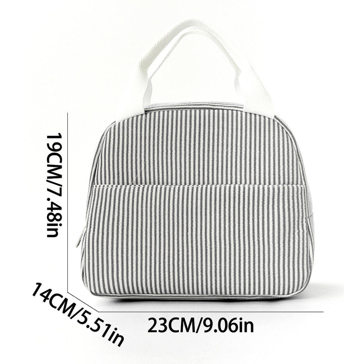 Lifestyle shot of striped insulated lunch bag carried by handle