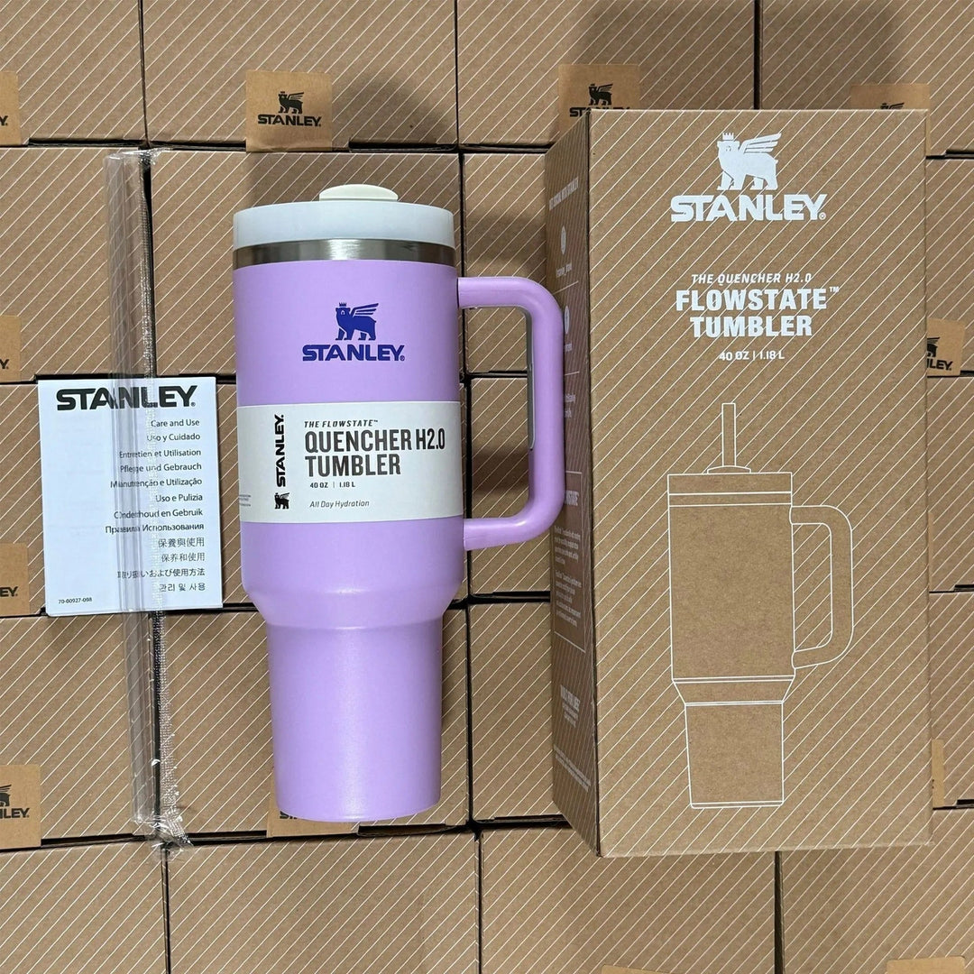 Purple insulated travel mug with handle and straw next to its box
