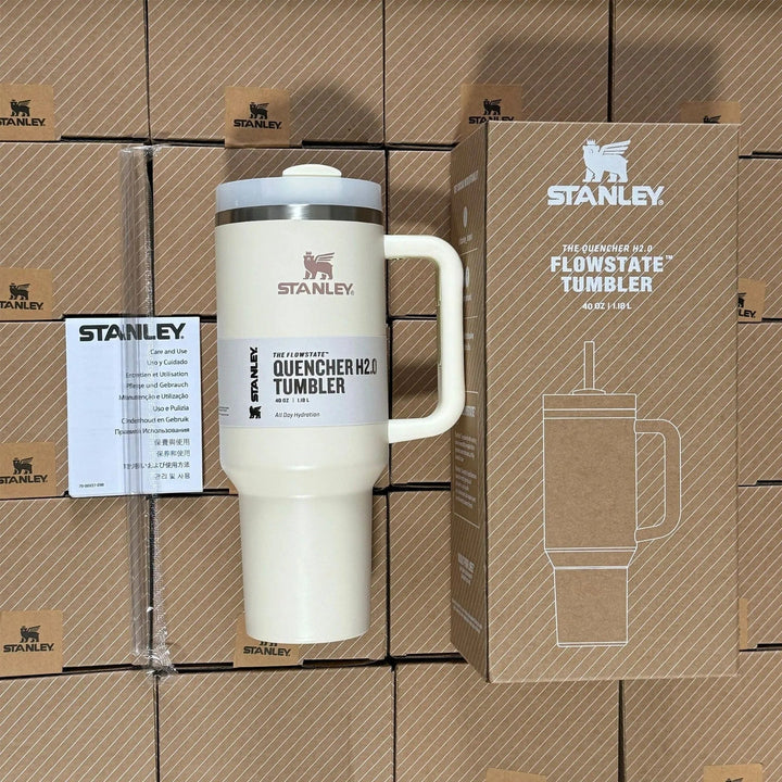 Insulated stainless steel travel mug with handle and straw in use