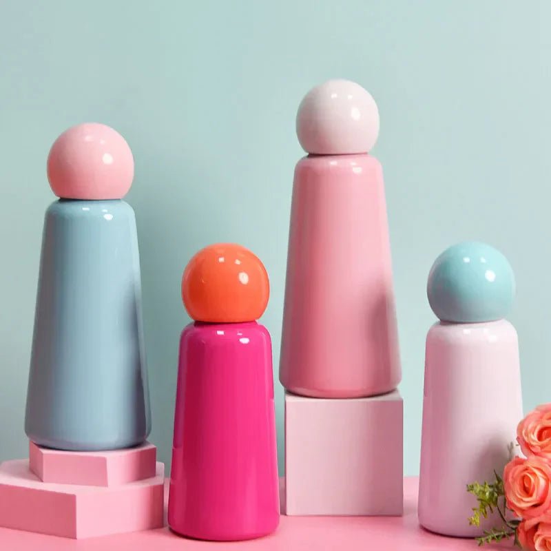 Colorful insulated water bottles with spherical lids displayed on pink and white stands