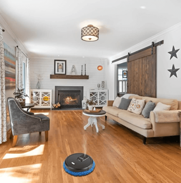 Modern robotic vacuum cleaning under furniture in a stylish living room