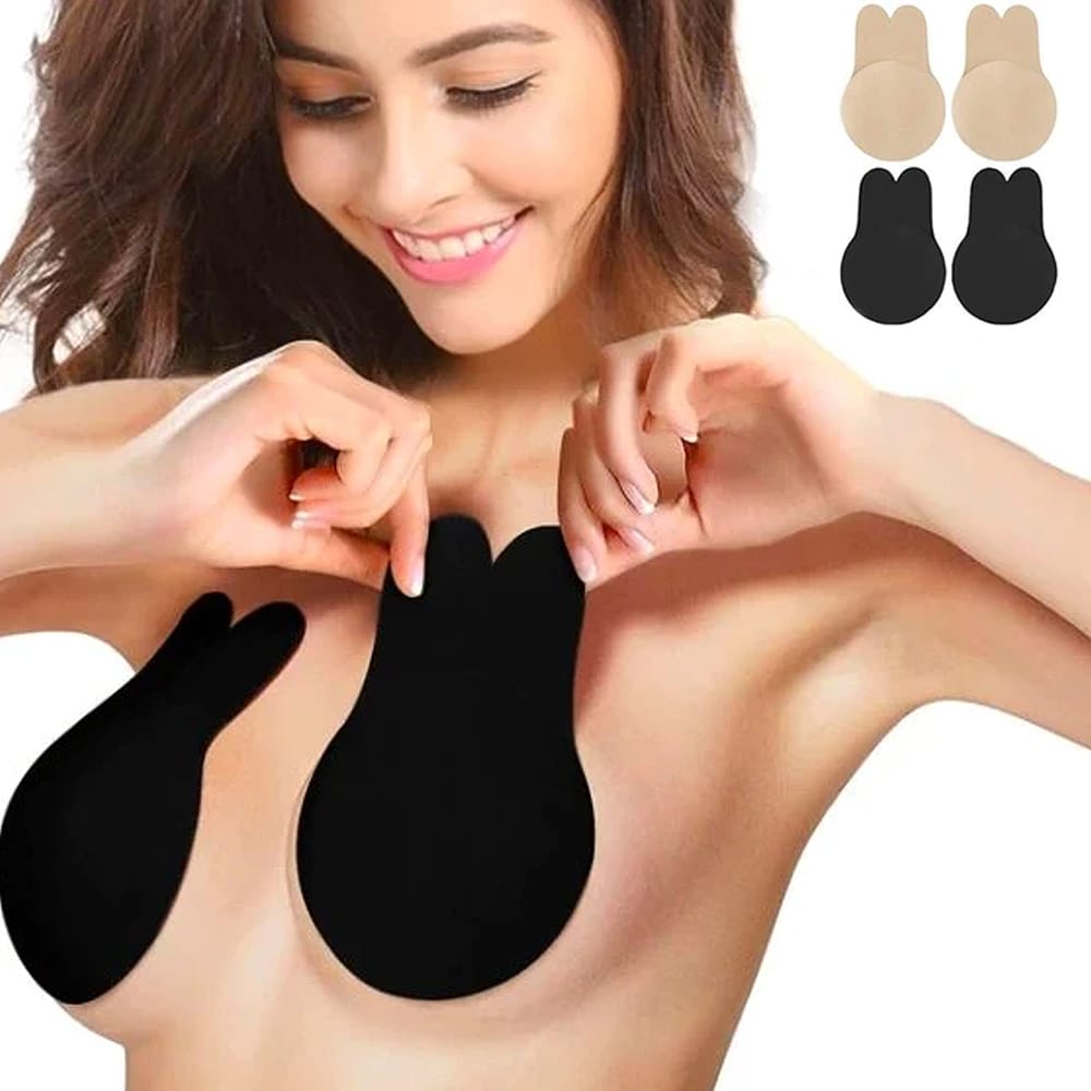 Woman holding black invisible push-up adhesive bra