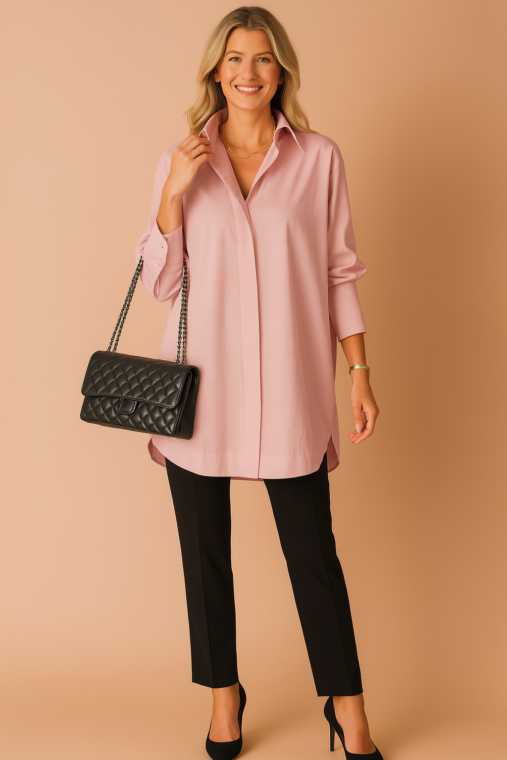 Woman wearing pink oversized shirt blouse with black trousers