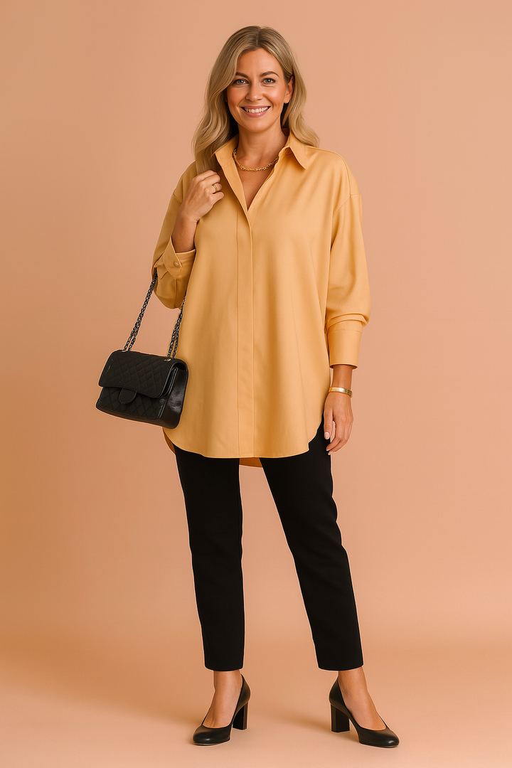 Woman wearing yellow oversized shirt blouse with black trousers