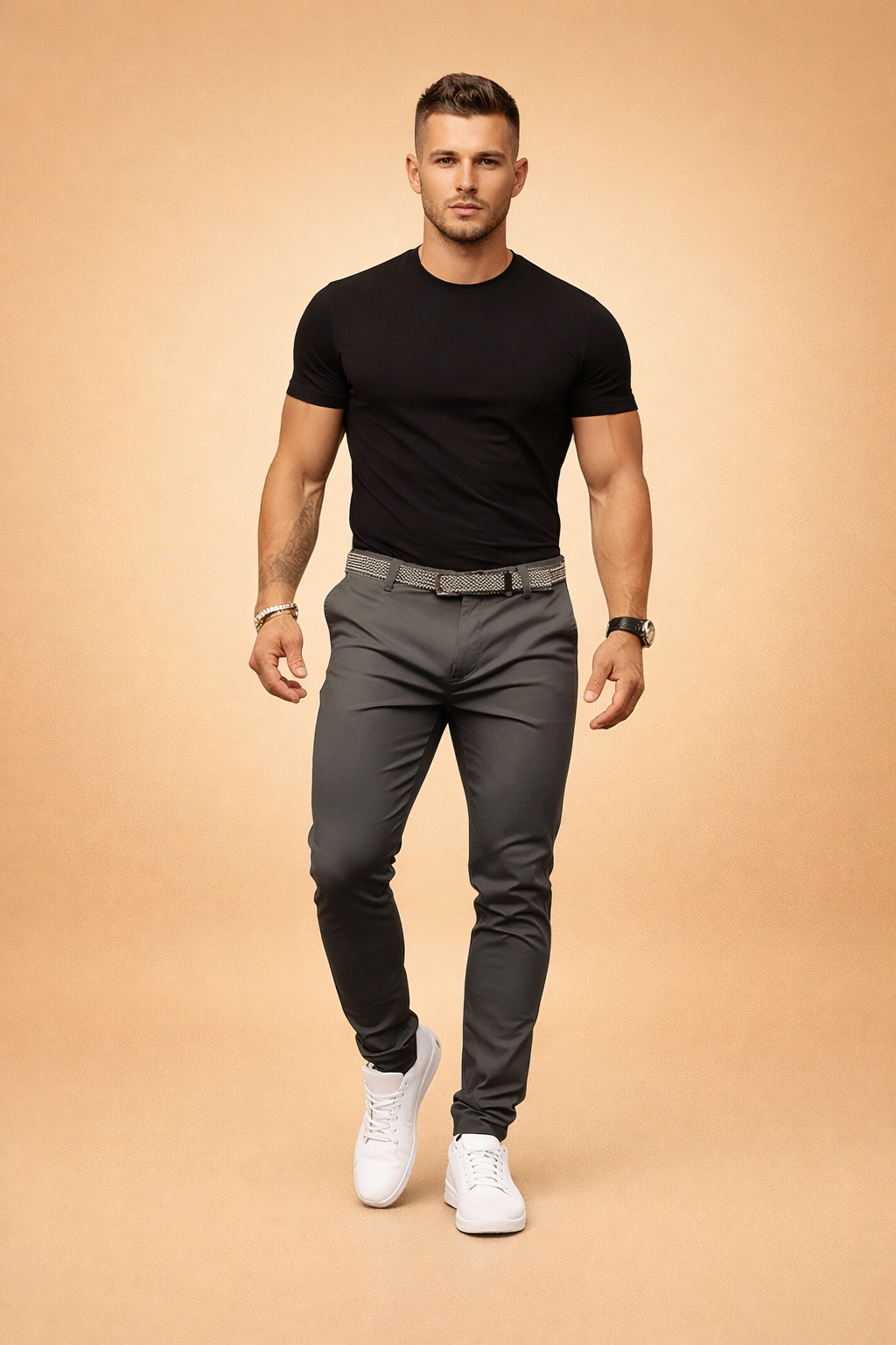 Man wearing slim fit trousers in anthracite with black t-shirt and white sneakers