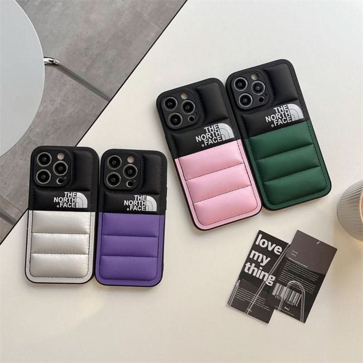 Puffer style iPhone case laid flat displaying camera cutout and sleek profile