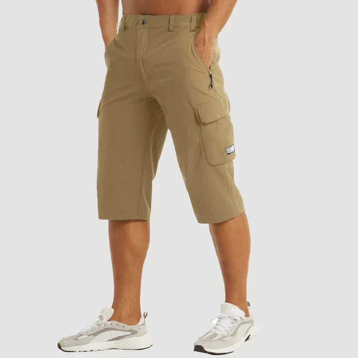 Man wearing khaki relaxed cropped cargo shorts with utility pockets