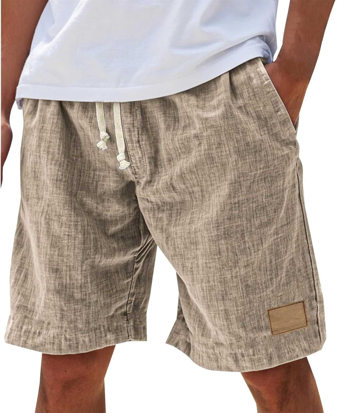 Man wearing khaki relaxed fit drawstring shorts with side pockets