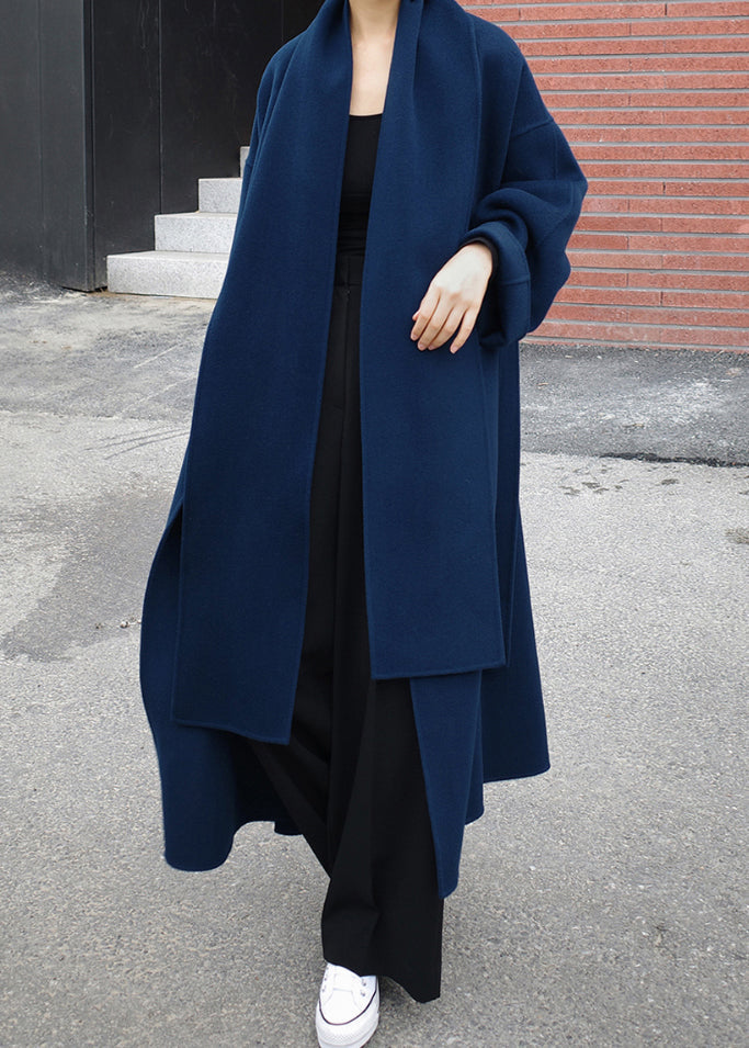 Close-up of the tailored blue winter coat paired with black trousers