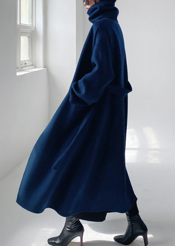 Back view of a women's blue tailored winter wool coat showing structured long coat design