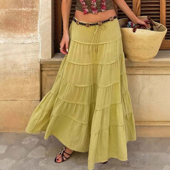Woman wearing a green tiered boho midi skirt outdoors