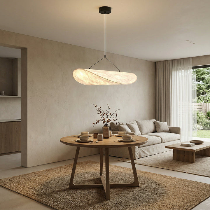 Japandi silk shade pendant light illuminating a modern dining table