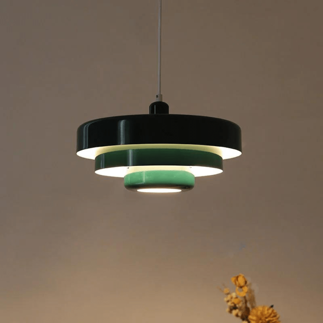 Green Bauhaus LED pendant lamp hanging in a warmly lit room interior