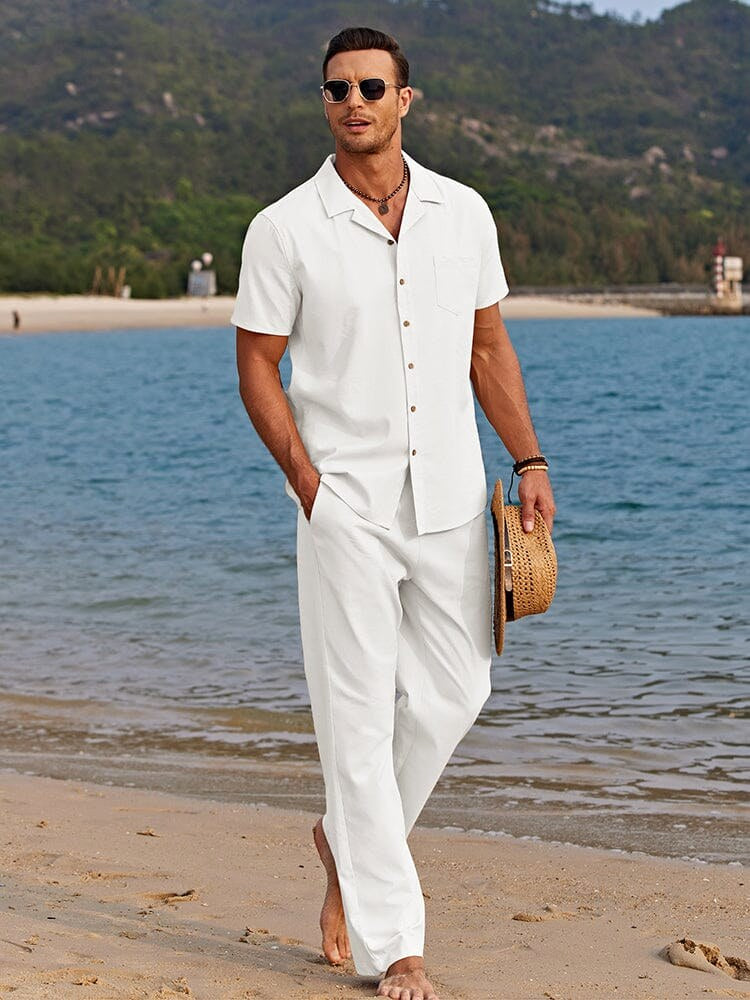 Man wearing white camp collar shirt and trousers set on the beach