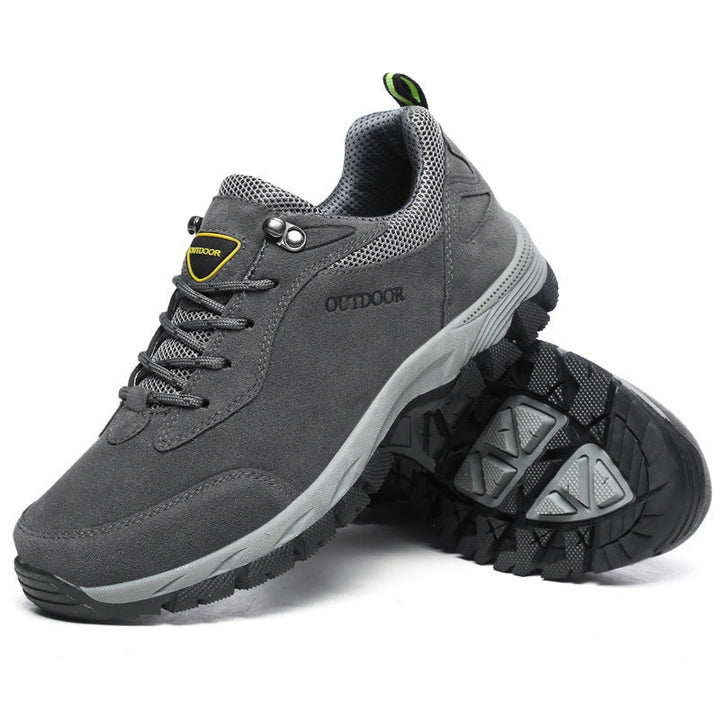 Gray men's outdoor orthopedic sneakers displayed with outsole view