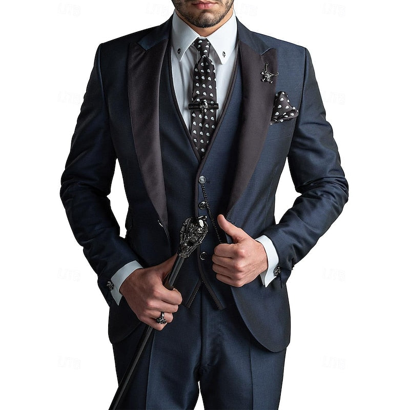 Man wearing a navy blue tailored three-piece suit with a patterned tie