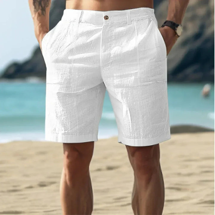Man wearing white casual mid length shorts on the beach
