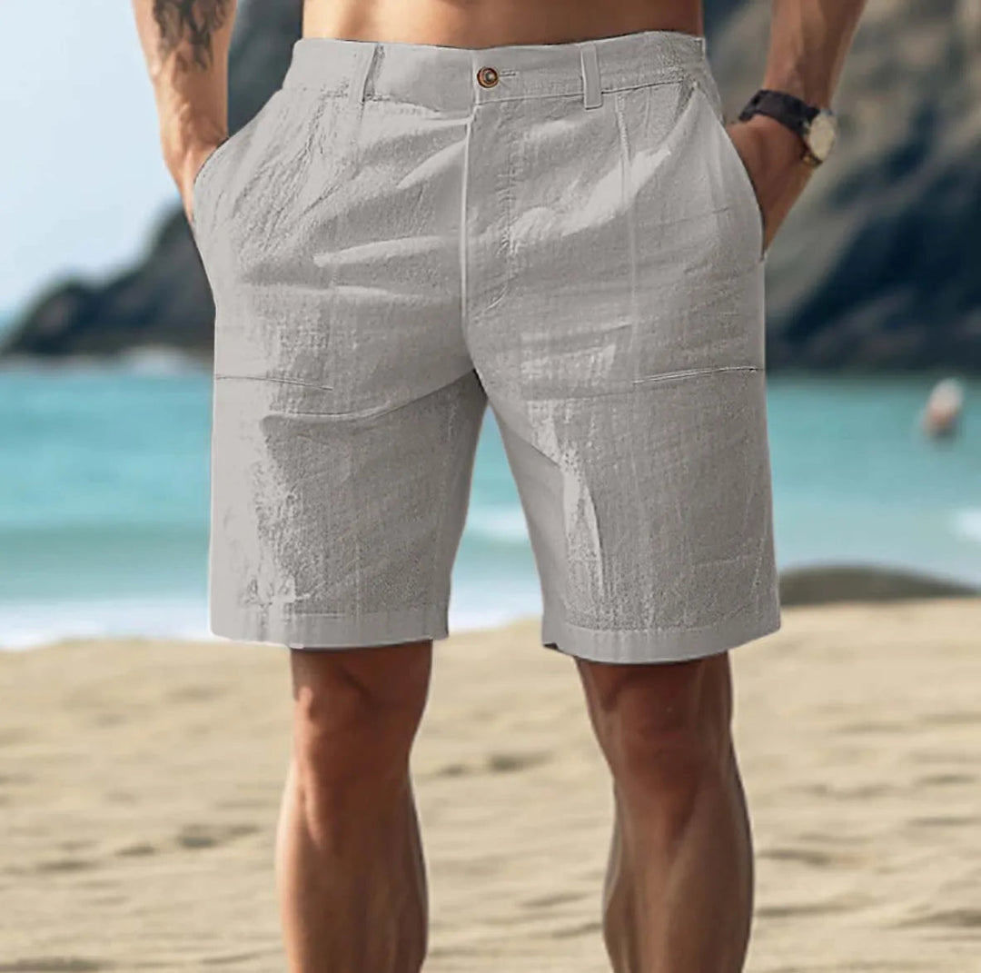 Man wearing gray casual mid length shorts by the coast