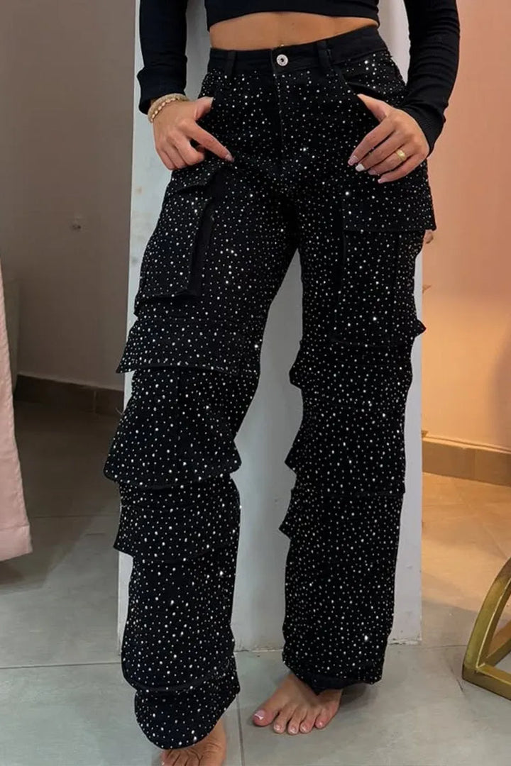 Close-up view of black rhinestone cargo jeans with multi-pocket design