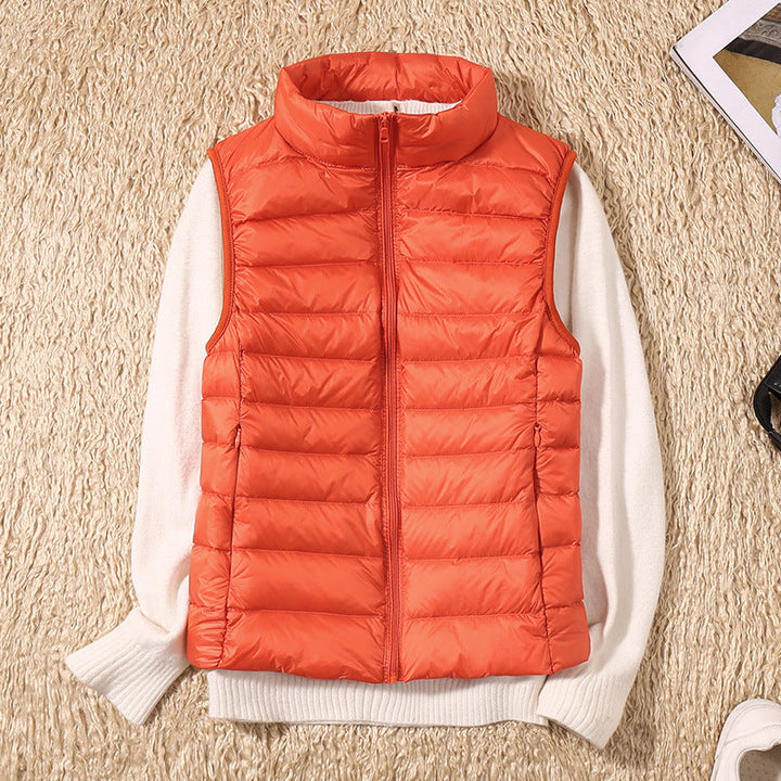Styling inspiration: women's puffer vest paired with long-sleeve top and jeans.
