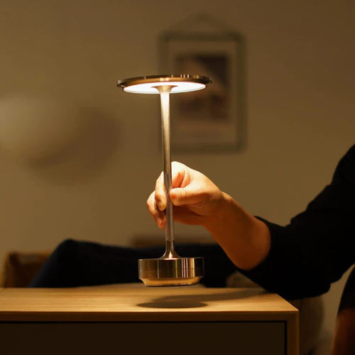 Minimalist cordless light casting warm glow on a living room table