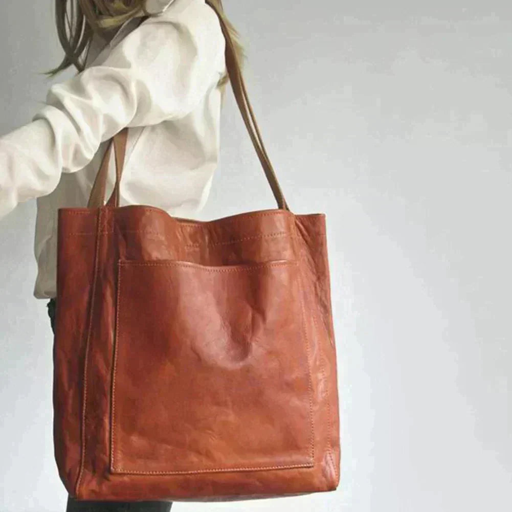 Woman wearing the stylish brown leather shoulder bag outdoors