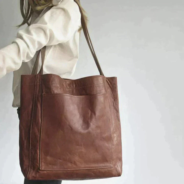 Close-up view of the coffee brown leather texture and stitching