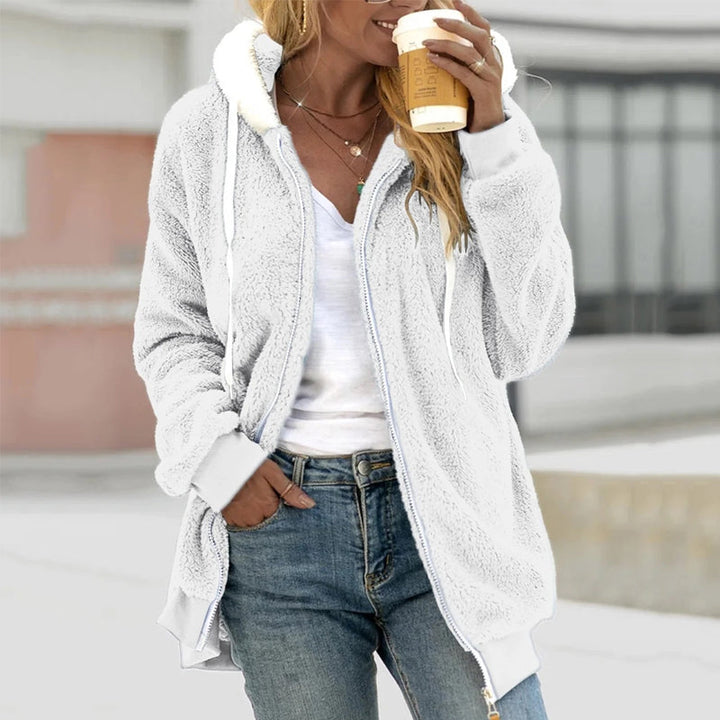 Full length view of a women's hooded zip-up longline coat in casual wear style