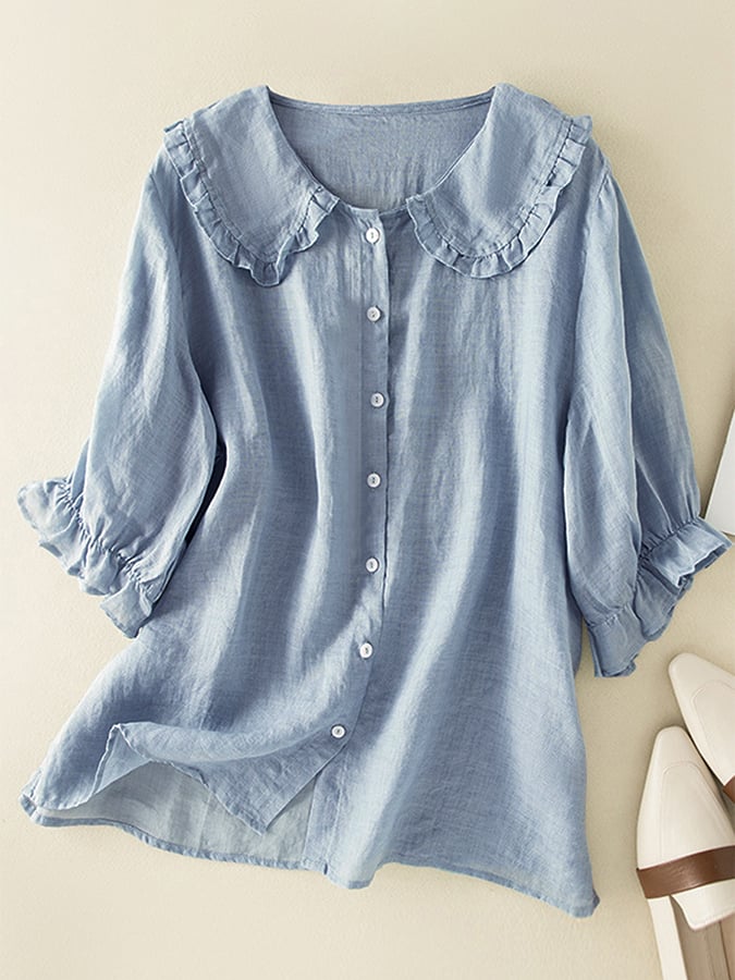 Blue women's ruffle collar button-down blouse laid flat
