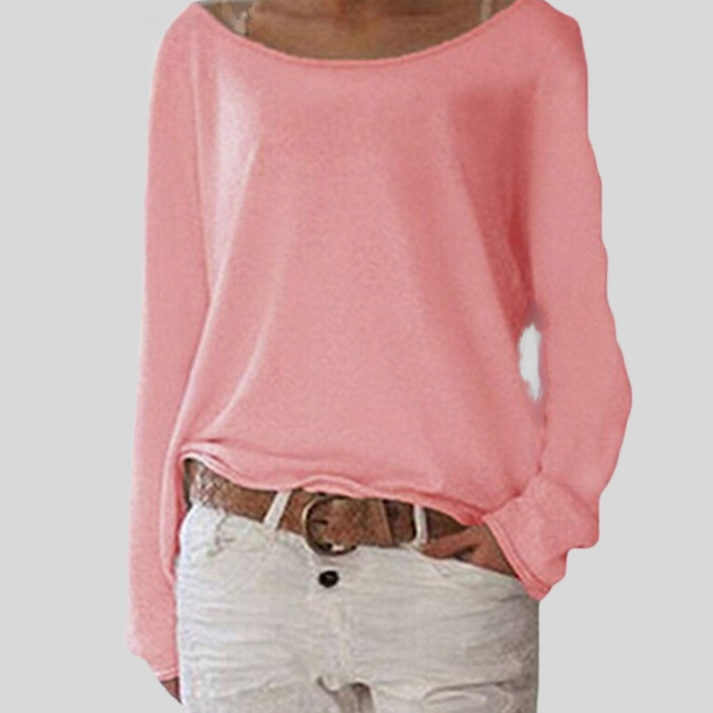 Woman wearing a pink relaxed fit long sleeve sweater paired with a belt