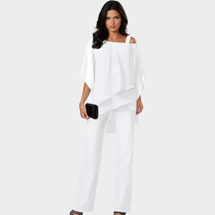 Model wearing the white chiffon overlay evening two-piece set with wide-leg trousers