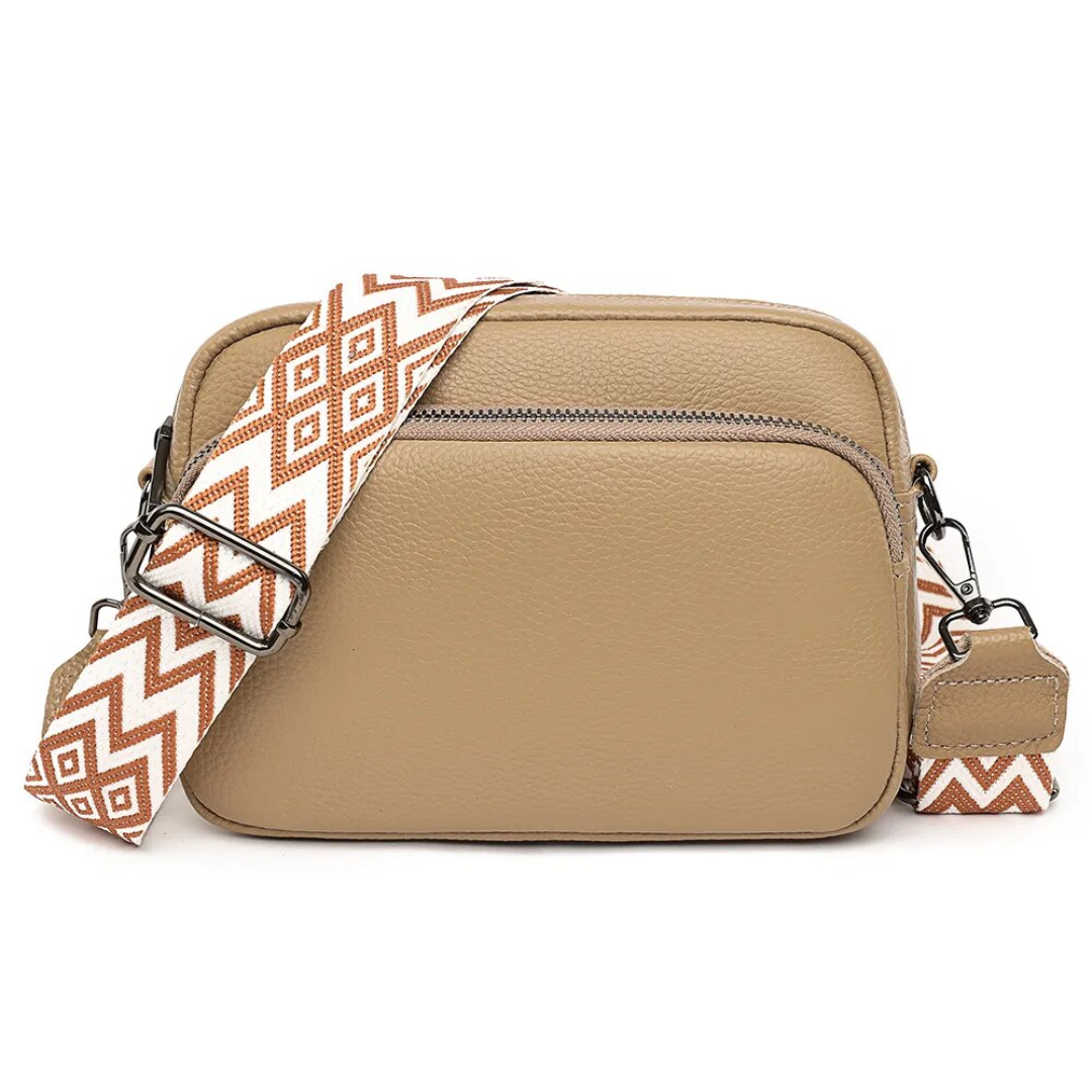 Flat lay of the womens crossbody bag with matching accessories