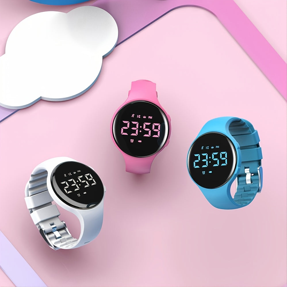 Three children's watches in white, pink, and blue displayed together on a colorful backdrop