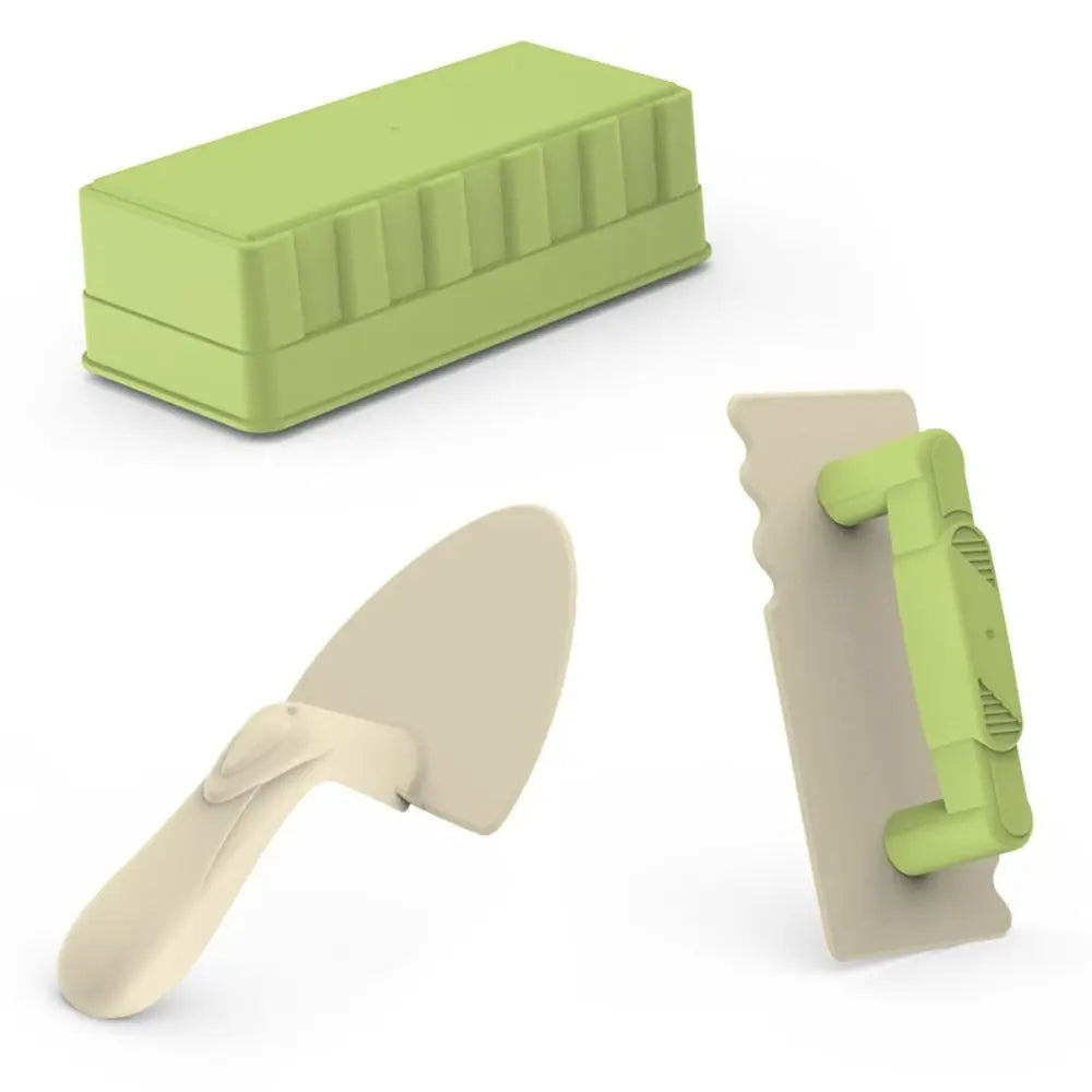 Green stone mold, beige spatula, and green-handled trowel toy set against a white background