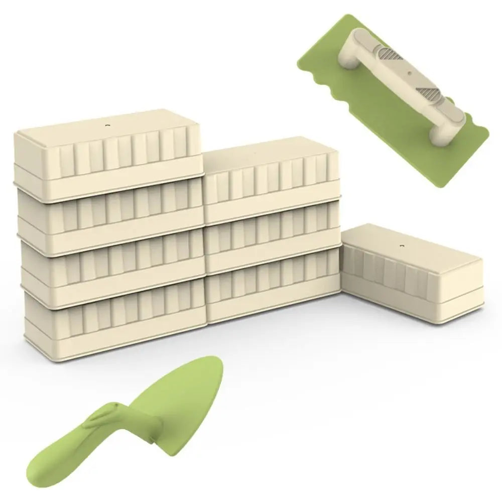 Stacked stone molds next to a green spatula and trowel toy set