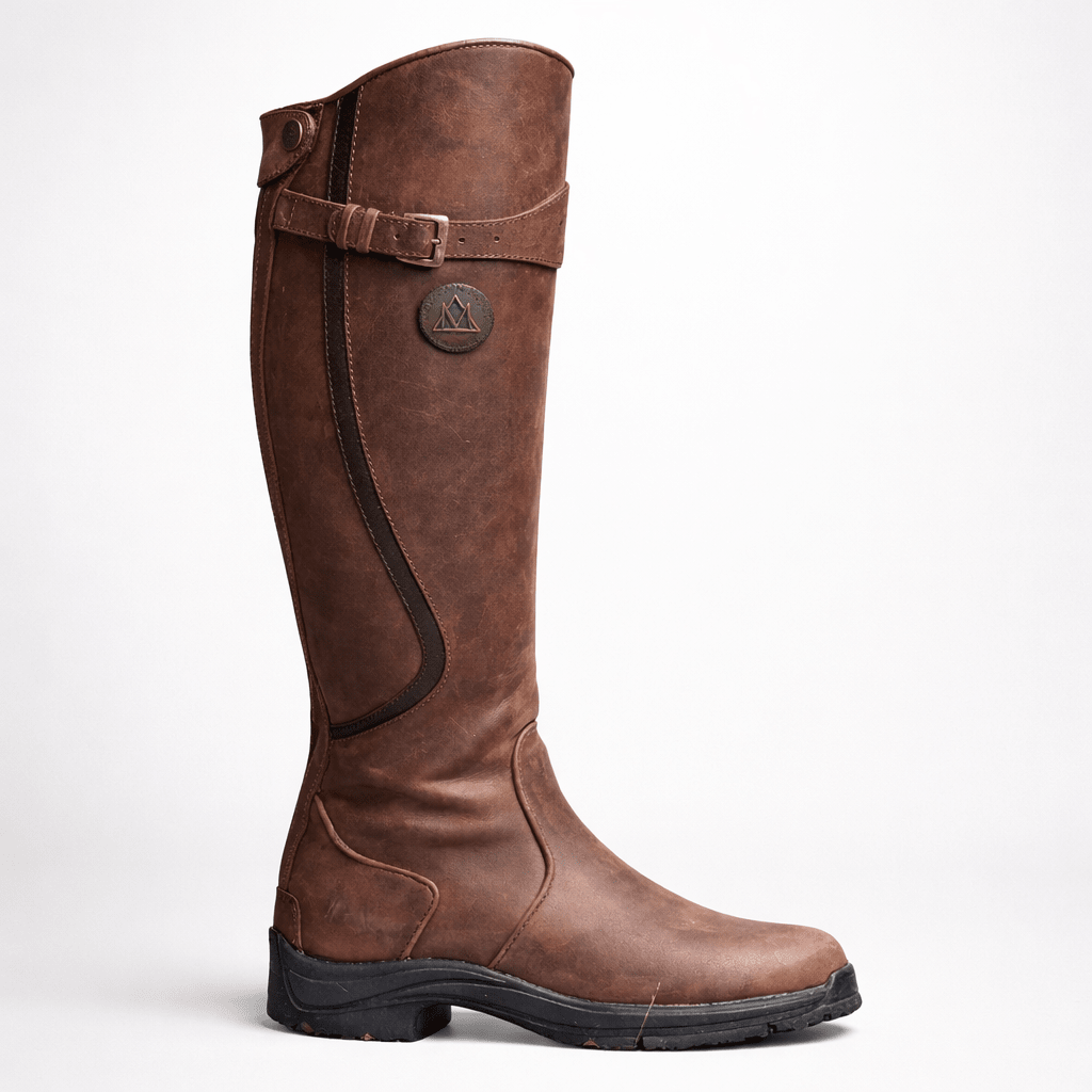 Close-up of brown tall equestrian boot showing buckle and shaft detail