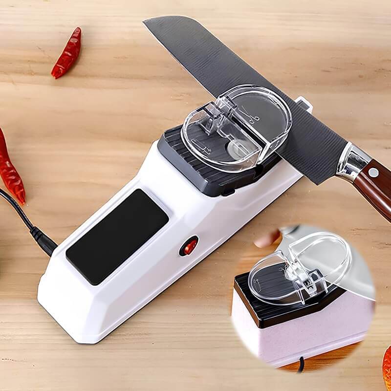 Electric knife sharpener actively sharpening a kitchen knife on a wooden table