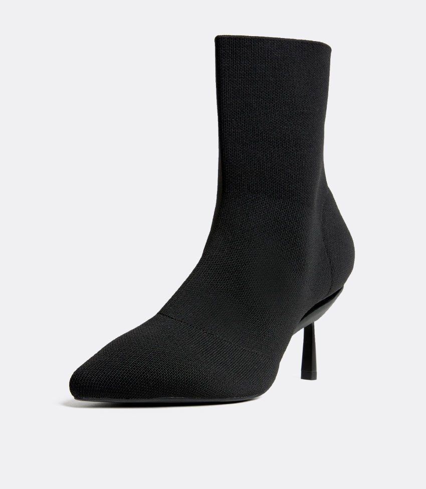 Women's black stretch knit pull-on boot side profile on white background