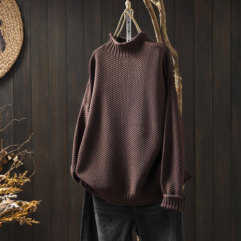 Coffee brown women's cozy knitted pullover sweater showcased on a rustic wooden backdrop