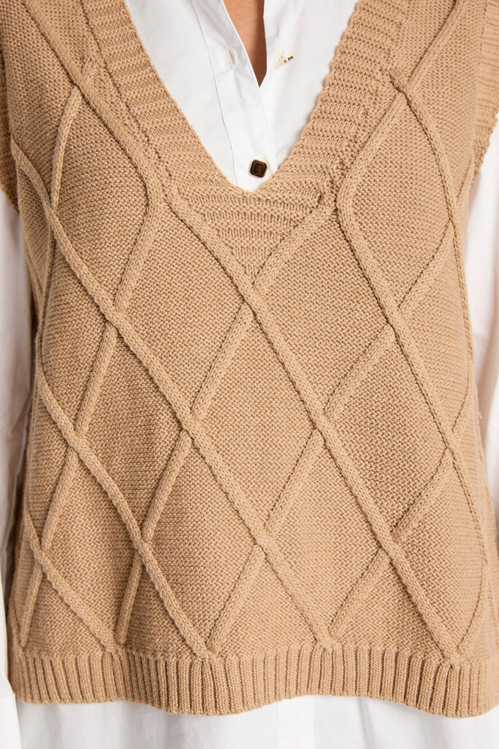 Mocha brown sleeveless sweater vest with geometric pattern styled on a model