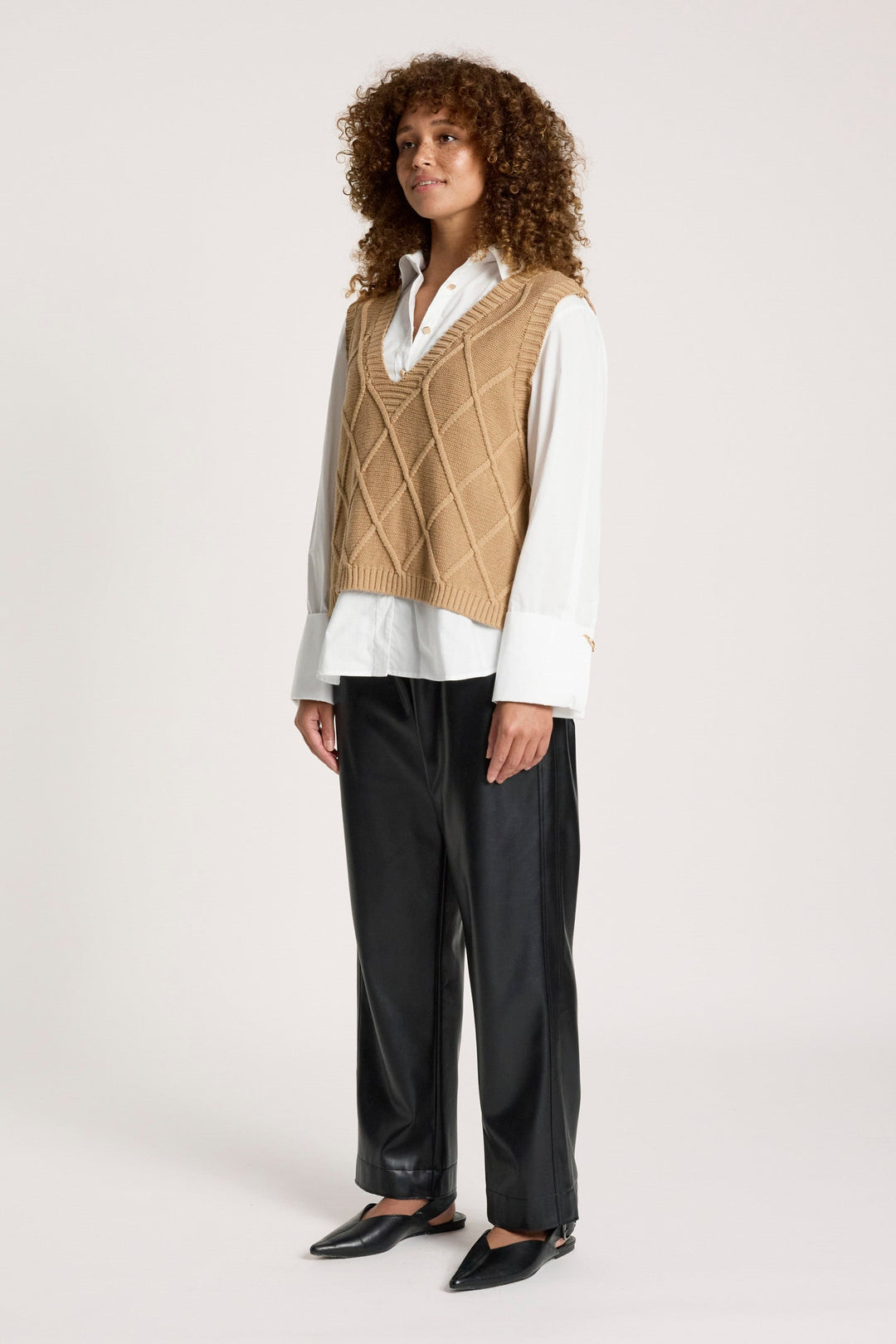 Back view of women's preppy fall fashion patterned knit vest