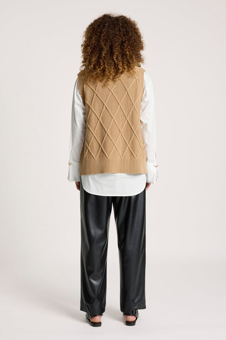 Detail of ribbed hem and neckline on women's patterned sweater vest