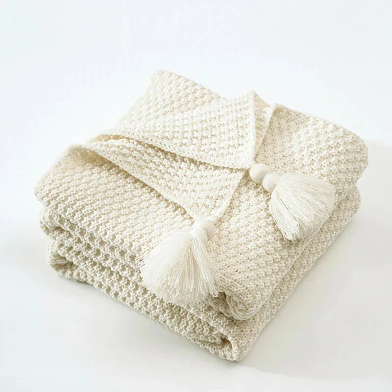 Decorative woven blanket with fringe details in a living room